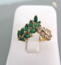 a ring with green and white stones on it