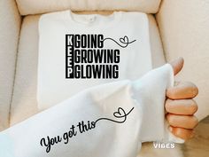 someone is holding up a t - shirt with the words going growing glowing on it