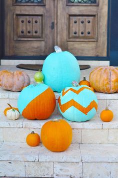 pumpkins and gourds are sitting on the steps