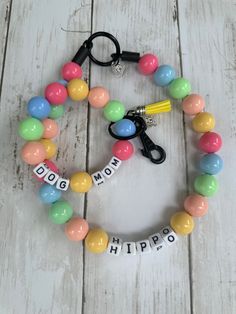 a colorful beaded bracelet with the word hippo on it and a pair of scissors