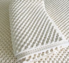 two pillows are laying on top of each other in the same pattern as they appear to be made out of foam