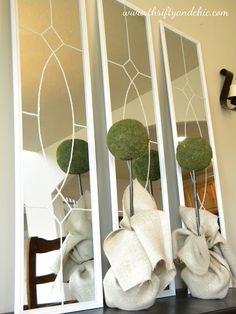 the mirror is decorated with green balls and bows on it's sides, along with other decorative items