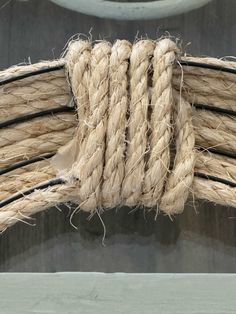 a close up of a rope on the side of a boat's hull with water in the background