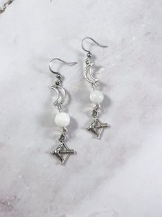 These Artemis earrings are the perfect accessory to show your love for the Greek gods in a subtle way! Made with moonstone gemstone, a moon charm, and a bow and arrow charm. Made with hypoallergenic fishhook style earrings. Two options are available: Stainless Steel Silver Plated Brass Ships in a jewelry box so it's ready to be give as a gift. All materials are lead and nickel free. Charm is made with zinc alloy. Earrings will be disinfected before shipment but should also be cleaned every time Greek Jewelry Goddesses, Greek Goddess Mythology, Artemis Jewelry, Dnd Jewelry, Greek Mythology Earrings, Aphrodite Earrings, Artemis Jewelry Moon Goddess, Goddess Mythology, Artemis Necklace