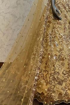 Description : This Lehenga Choli is Ready to Wear Golden attached cancan lehenga with sequin, floral embroidery. Paired with a padded blouse with all over beads, sequins, thread work and dupatta. Details : No of Components: 3 Components: Blouse, Dupatta, Lehenga Pattern: Embroidery Type of Work: Sequins, & Thread Work Neckline: Sweetheart Neck Sleeve Type: Sleeveless Fabric: Net Color: Golden Other Details: Attached inner lining Lehenga Length: 46.5 inches Blouse Chest : 36 Occasion: Bride, Dest Sequin Net Lehenga For Festivals, Party Lehenga With Mirror Work And Net, Festival Net Lehenga With Sequins, Party Lehenga With Mirror Work, Party Wear Floor-length Dupatta For Celebration, Organza Traditional Wear With Sequins For Diwali, Organza Traditional Wear With Sequins For Navratri, Gold Georgette Lehenga For Party Wear, Floor-length Party Wear Dupatta For Celebrations