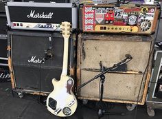 an old guitar and amp are stacked on top of each other