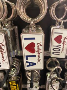 i love you to the moon and back keychains are hanging from hooks in a store