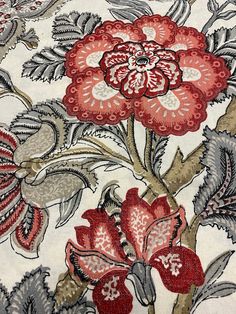 a red and white floral design on fabric