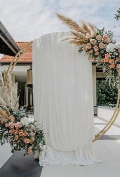 a wedding arch with flowers and pamodia