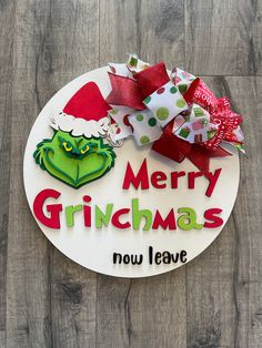 the grinchmas sign is decorated with red and green bows