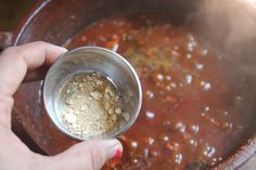 a person is stirring some food in a pot