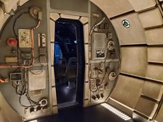 the inside of a space station with many electronic devices on it's walls and doors