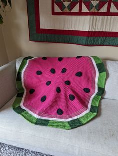 a watermelon blanket sitting on top of a couch