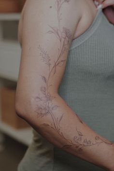 a woman with a flower tattoo on her arm