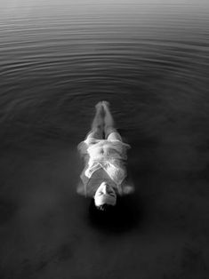 a woman floating on top of a body of water