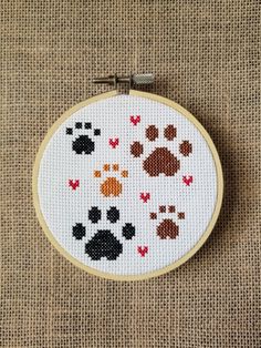 a cross stitch pattern with paw prints on it