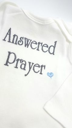 Answered Prayer newborn cotton crossover shirt or romper is perfect for the hospital and all those first photo ops. This shirt is adorable for baby shower gifts, adoption gifts and hospital gifts for the new parents. Add a personalized hat for the perfect outfit! https://www.etsy.com/listing/562195188/personalized-baby-boy-hat-baby-name?ref=shop_home_active_2 https://www.etsy.com/listing/565645457/personalized-newborn-hat-newborn-hat?ref=shop_home_active_4 https://www.etsy.com/listing/490933392/ Newborn Hospital Keepsake, Personalized Short Sleeve Onesie As Gift, Personalized Cotton Onesie For Gender Reveal, Personalized Short Sleeve Onesie For Gift, Coming Home From Hospital, Birthing Gown Hospital, Cute Cotton Onesie For Baptism, Cotton Baptism Onesie With Short Sleeves, Personalized Cotton Onesie For Baptism