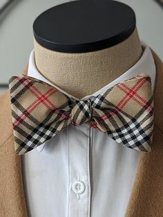 Step up your style game with our handcrafted Designer Plaid Bow Tie. Made from high-quality brushed cotton, these self-tie accessories add a touch of elegance and sophistication to any occasion. Whether you're attending a wedding, a formal event, or simply want to elevate your everyday look, our Designer Bow Ties are the perfect choice. With their classic design and impeccable craftsmanship, these bow ties are sure to turn heads. The plaid pattern adds a timeless charm, making them suitable for Plaid Bow Tie, Tan Plaid, Plaid Bow, Tie Accessories, Brushed Cotton, Suit And Tie, Bow Ties, Men Clothing, Polished Look