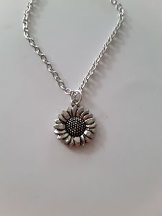 sunflower charm necklace, antique silver charm, dainty, fun gift Silver Alloy Necklace With Flower Pendant, Silver Alloy Flower Pendant Necklace, Everyday Silver Necklace With Vintage Charm, Silver Charm Necklace In Alloy, Adjustable Metal Necklace With Flower Charm, Nickel Free Flower Pendant Charm Necklaces For Everyday, Nickel-free Flower Pendant Charm Necklaces For Everyday, Silver Flower Pendant Charm Necklace For Everyday, Handmade Pendant Charm Necklaces In Alloy