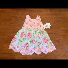 Sleeveless Pink And White Flowered Dress Cross Back With Bow (New With Tags) White Floral Print Sleeveless Cotton Dress, White Cotton Sleeveless Dress With Floral Print, Cute Sleeveless Dress For Spring Playtime, Cute White Sleeveless Dress For Garden Party, Sleeveless Floral Print Dress For Dress-up, Cute Sleeveless Spring Dress, Cute Sleeveless Floral Dress For Beach, Sleeveless Summer Floral Dress For Dress-up, Cute Fitted Sleeveless Floral Dress