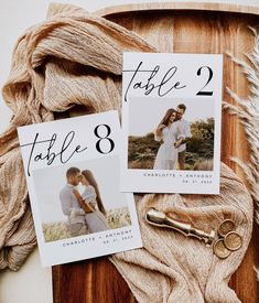 the wedding table numbers are displayed on top of a wooden board with scissors and yarn