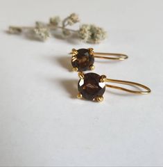 Smokey quartz earrings, gold delicate earrings, gold vintage earrings, classic earrings, birthstone earrings, brown gemstone earrings, gift for her These vintage inspired earrings were delicately handmade and are minimalist and classic. They are made of 14k gold filled and 14k gold plated brass. Dimensions: Gemstone size is 7X7 mm, with a facet finish Total drop is 0.75 inches. Can be ordered in sterling silver or other gemstones. Just let me know what you like and I will do my best to accommoda Classic Brown Jewelry With Matching Earrings, Elegant Brown Brass Earrings, Elegant Brown Brass Jewelry, Vintage Brown Earrings For Everyday, Elegant Brown Earrings For Anniversary, Classic Brown Round Earrings, Green Amethyst Earrings, Smoky Quartz Earrings, Vintage Inspired Earrings