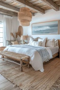 a large bed sitting in a bedroom next to a wooden table and lamp on top of a rug