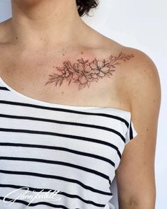 a woman with a flower tattoo on her chest