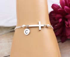 "Sideways Cross Bracelet. PLEASE CLICK \"MORE\" BELOW TO READ FULL DESCRIPTION and sizing information. This simple and elegant Cross Bracelet features a sterling silver Cross accented with two Swarovski Pearls and a sterling silver initial on a sterling silver chain finished with a lobster clasp closure. Bracelet is solid sterling silver, fully adjustable and comes with the option to add a complimentary, custom printed gift tag. BRACELET DETAILS: * Sterling silver cable chain finished with a sec Hypoallergenic Sterling Silver Pearl Bracelet, Silver Cross Bracelets For Gifts, Nickel Free Sterling Silver Cross Bracelets, Nickel-free Sterling Silver Pearl Bracelet Gift, Nickel-free Sterling Silver Pearl Bracelet, Elegant Personalized Cross Bracelets, Sterling Silver Bracelet Jewelry For Mother's Day, Silver Cross Chain Bracelet As Gift, Adjustable Sterling Silver Pearl Bracelet For Anniversary