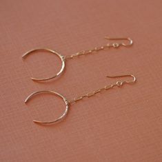 Handcrafted 14k gold filled or sterling silver crescent moon earrings dangle from long rectangle chain. The crescent is formed and hammered from 18 gauge wire into an eye-pleasing crescent shape. Each one is crafted by hand, hammered for texture and then polished to a brilliant shine. While these earrings make a statement on your ears they won't weigh you down. They are very lightweight. Shop Home: HTTP:www.etsy.com/shop/LHJewelryBoutique See More Long Gold Earrings: http://www.etsy.com/shop/lhj Moon Earrings Gold, Gold Crescent Moon, Long Gold Earrings, Crescent Moon Earrings, Tourmaline Earrings, Crescent Shape, Gold Dangle Earrings, Hammered Gold, Gemstone Studs