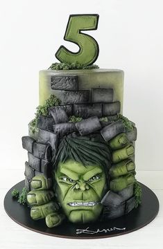 a cake with the number five on top of it and a hulk face in front