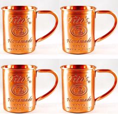 four copper colored coffee mugs sitting side by side