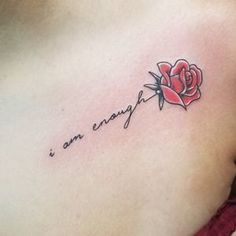 a woman's chest with a rose and the words i am enough on it