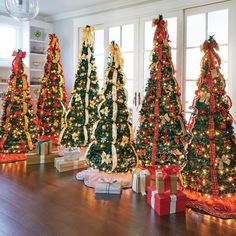 christmas trees with bows and presents on the floor