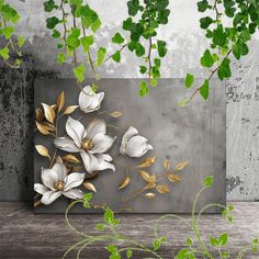 some white flowers and green leaves on a gray background