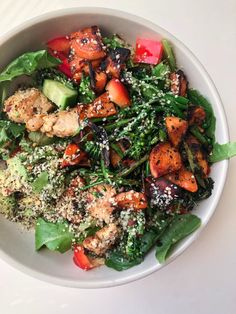 a white bowl filled with vegetables and meat