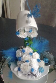 a white cake with blue and white flowers on it sitting on top of a table