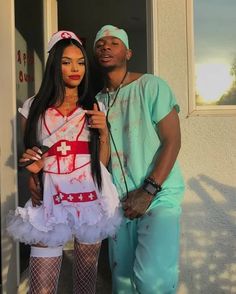 a man standing next to a woman dressed as a nurse in front of a house