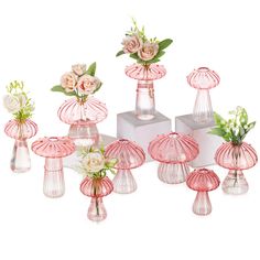 a group of pink vases with flowers in them