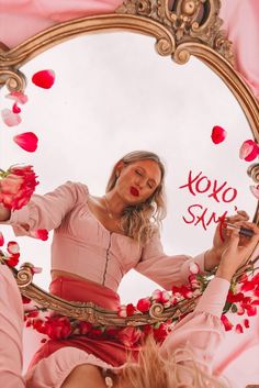 a woman looking at herself in the mirror with roses all over her body and hair