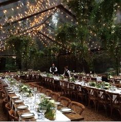 an indoor venue with tables and chairs set up for dinner