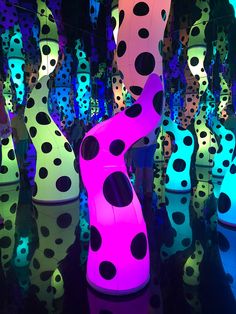 colorful lights are lit up in the shape of polka dotes and shapes that appear to be floating