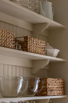 baskets and bowls on shelves in a kitchen