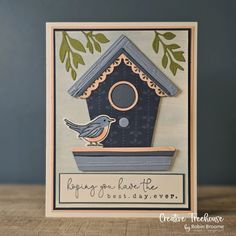 a card with a bird sitting on top of a birdhouse that says happy new home