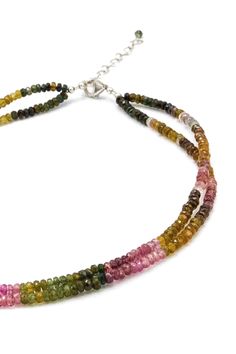 multicolored beaded necklace with silver clasps and beads on a white background