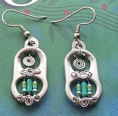 two pairs of earrings with green beads on them