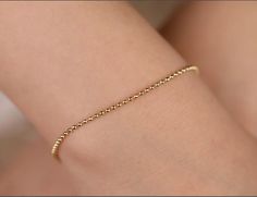 This simple yet elegant Ball Chain Bracelet will fit any style. You'll love the versatility of this bracelet. Mix it up to create your own fashion rules. Comes in 3 sizes for a comfortable fit. - Handmade- Solid Gold- Chain Width: 1 mm - 1.3 mm - 1.5 mm- High-End Polish All pieces come beautifully boxed in suede pouches you can always use (which really comes in handy when traveling!) Elegant Flexible Yellow Gold Bracelet, Elegant Beaded Chain Bracelet With Round Beads, Dainty Beaded Bracelets With Ball Chain, Delicate Round Beads Chain Bracelet, Minimalist Beaded Bracelets With Delicate Chain, Elegant Adjustable Ball Chain Bracelet, Elegant Everyday Ball Chain Bracelets, Delicate Bracelet With Adjustable Chain And Round Beads, Dainty Ball Chain Bracelet For Everyday