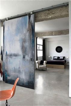 an open door leading to a bedroom with a large painting on it's wall