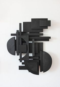 an abstract sculpture made out of black wood