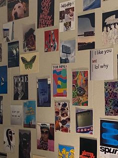 a wall covered in posters and magnets next to a refrigerator freezer with the words i like you on it